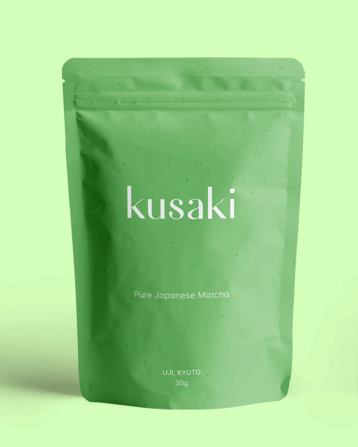 Kusaki Japanese ceremonial matcha green tea pouch hovering over green background